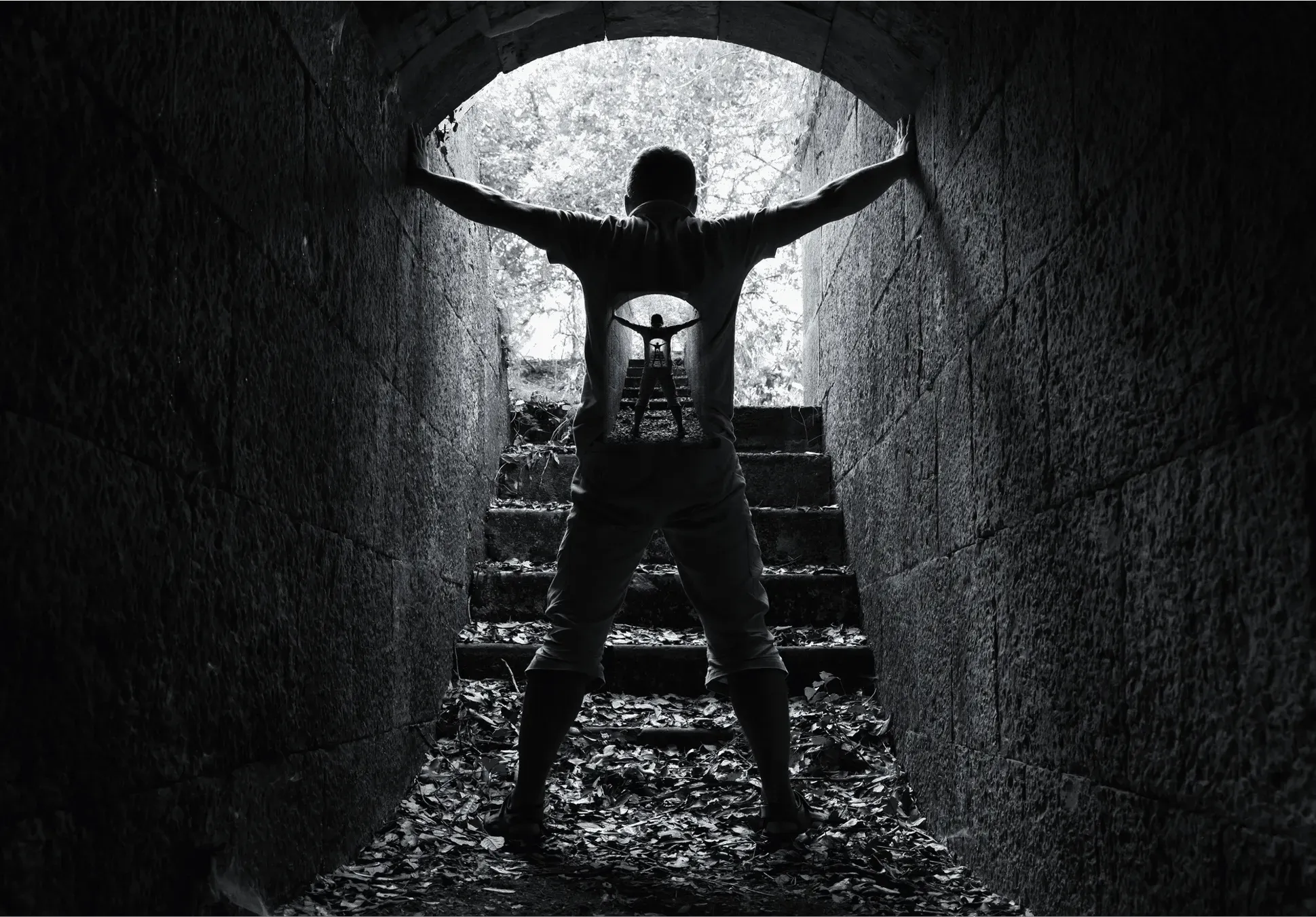 A figure in a tunnel opening